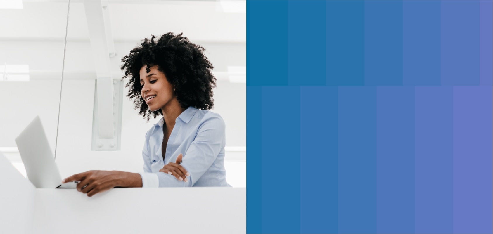 Woman works on her laptop at her office desk.