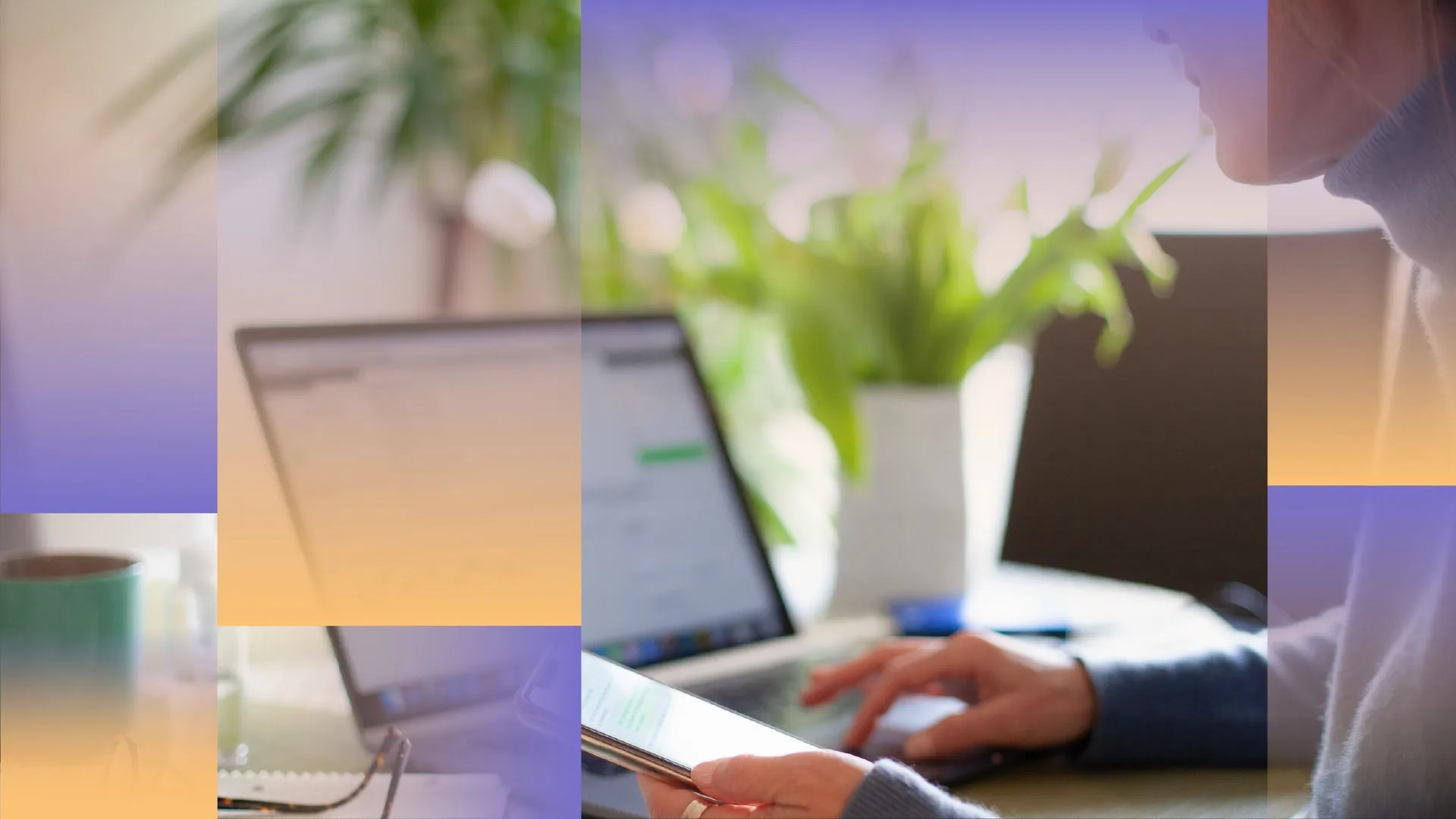 Side photo of a woman working at her laptop while holding a mobile phone.